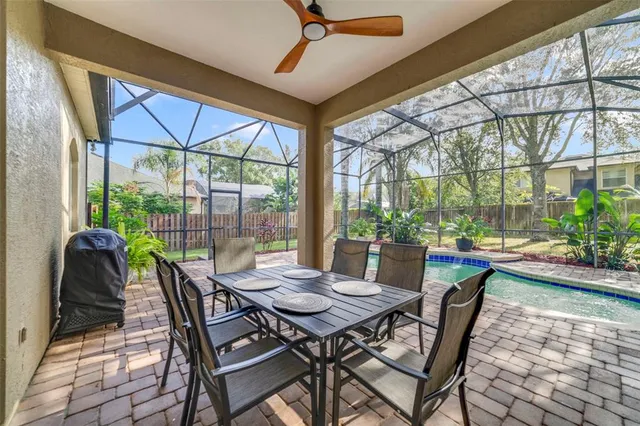 a view of an outdoor dining space with a table and chairs