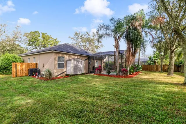 a view of a house with a yard and sitting area