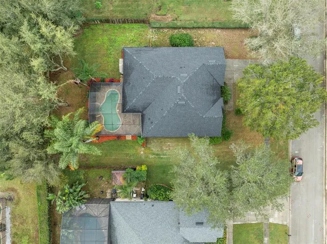 an aerial view of a house with a yard
