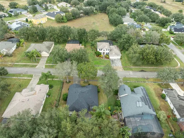 an aerial view of a house with yard swimming pool and outdoor seating