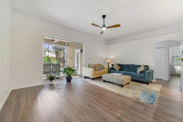 a living room with furniture and a wooden floor