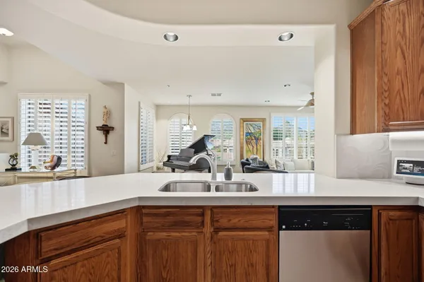 a kitchen with granite countertop a sink and cabinets