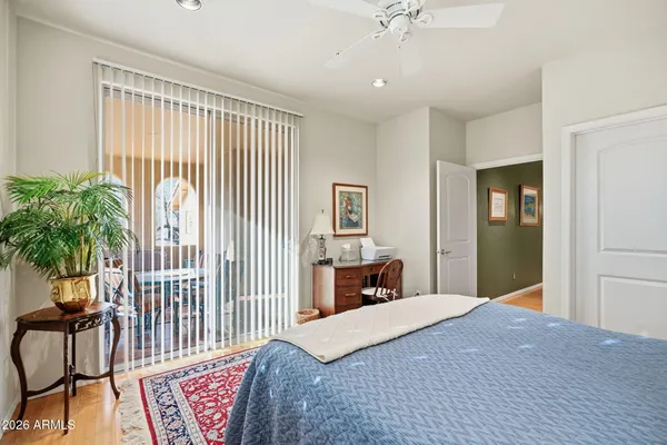 a bedroom with a bed and large windows