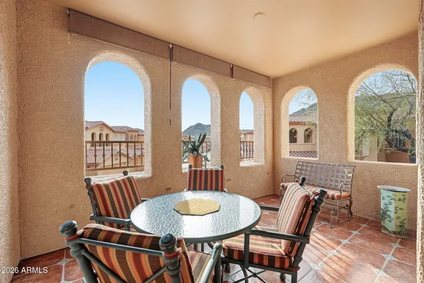 a view of a chairs and table in the balcony