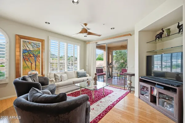 a living room with furniture a flat screen tv and a large window