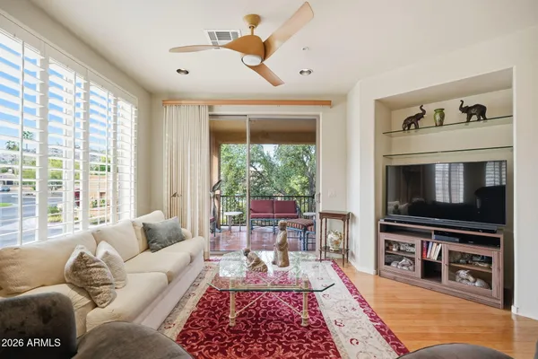 a living room with furniture fireplace and a large window