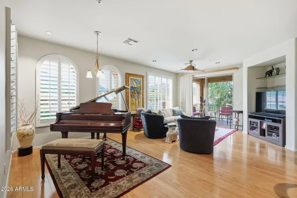 a living room with furniture and a wooden floor