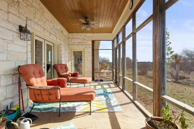a living room with furniture potted plant and a large window