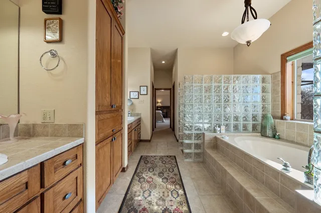 a large kitchen with granite countertop a sink and cabinets