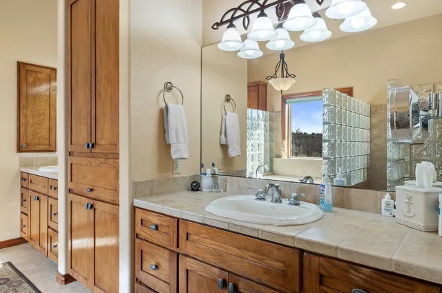 a kitchen with stainless steel appliances kitchen island granite countertop a refrigerator a stove and a sink with wooden floor