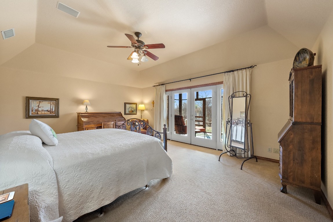8095 Ranch To Market Road 2618 Fredonia, TX 76842 - Photo 19 of 39 a bedroom with a large bed and a chandelier