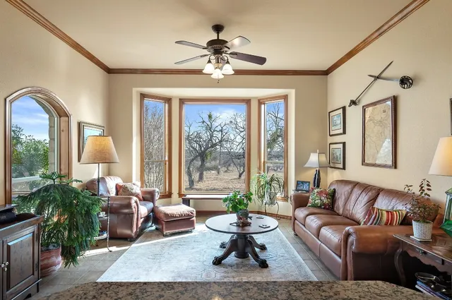 an aerial view of a house with yard and trees