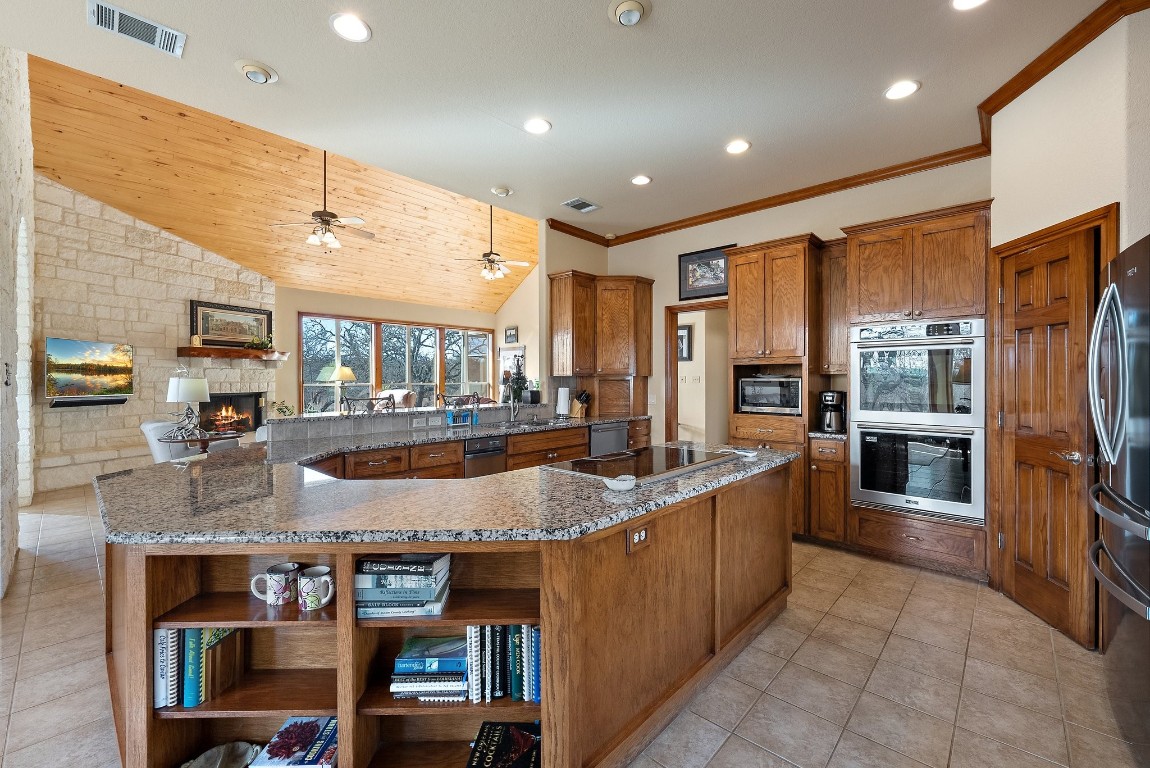 8095 Ranch To Market Road 2618 Fredonia, TX 76842 - Photo 24 of 39 a large kitchen with stainless steel appliances granite countertop a large counter top and stove