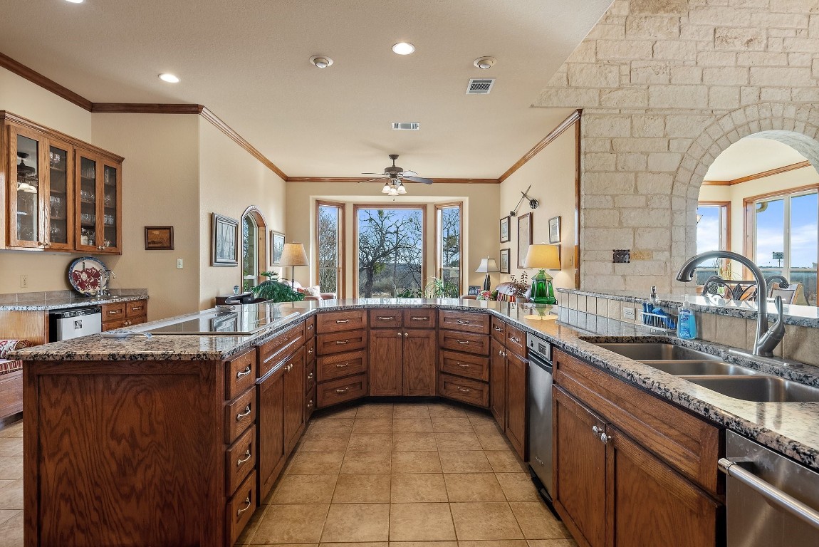 8095 Ranch To Market Road 2618 Fredonia, TX 76842 - Photo 25 of 39 a large kitchen with granite countertop a sink and cabinets
