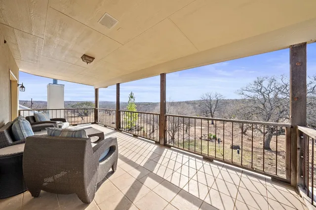 a bed room with a bed and a view of living room