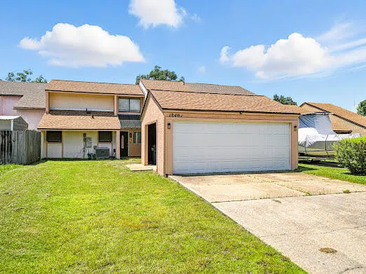 a front view of a house with a garden and yard