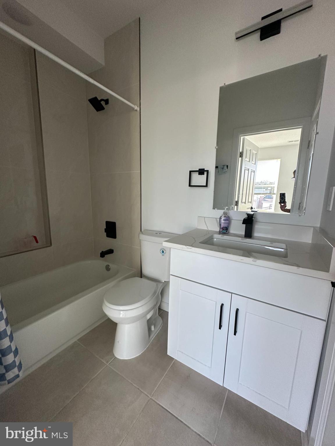 1925 H Street Northeast, Unit 3 Washington, DC 20002 - Photo 10 of 33 a bathroom with a double vanity sink a toilet a mirror and shower