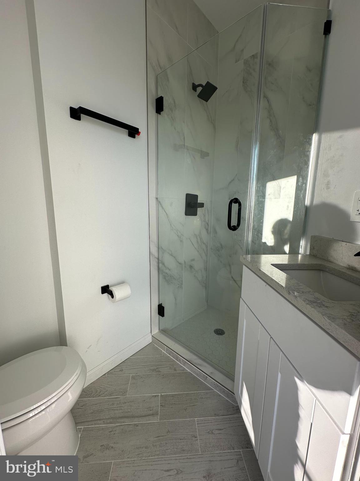 1925 H Street Northeast, Unit 3 Washington, DC 20002 - Photo 18 of 33 a bathroom with a granite countertop sink a toilet and shower