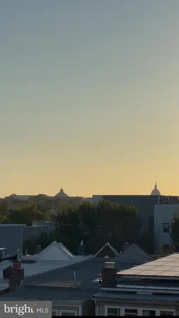 an aerial view of residential houses with a city view