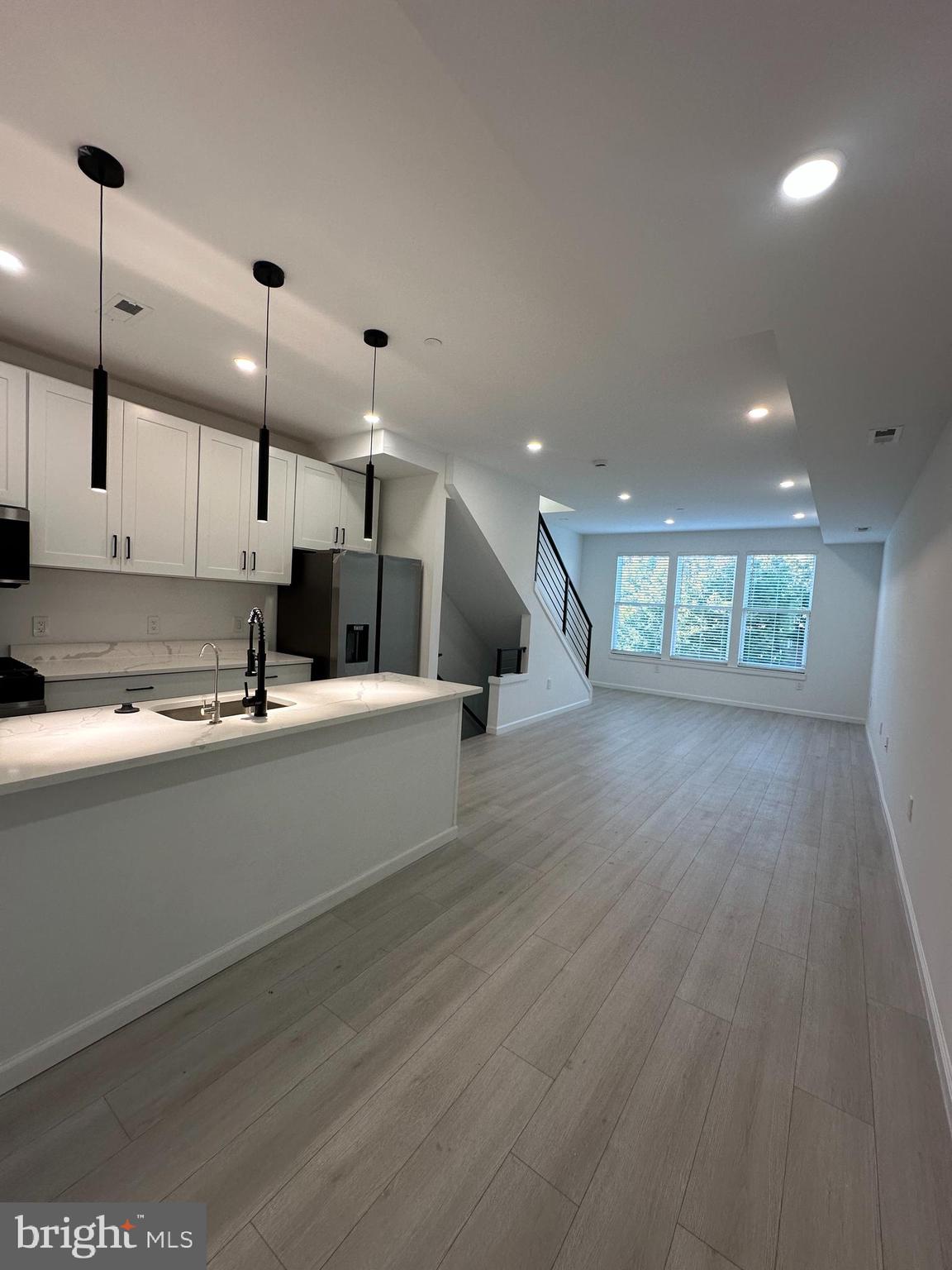 1925 H Street Northeast, Unit 3 Washington, DC 20002 - Photo 33 of 33 a large kitchen with stainless steel appliances kitchen island a large counter space a sink and a large window