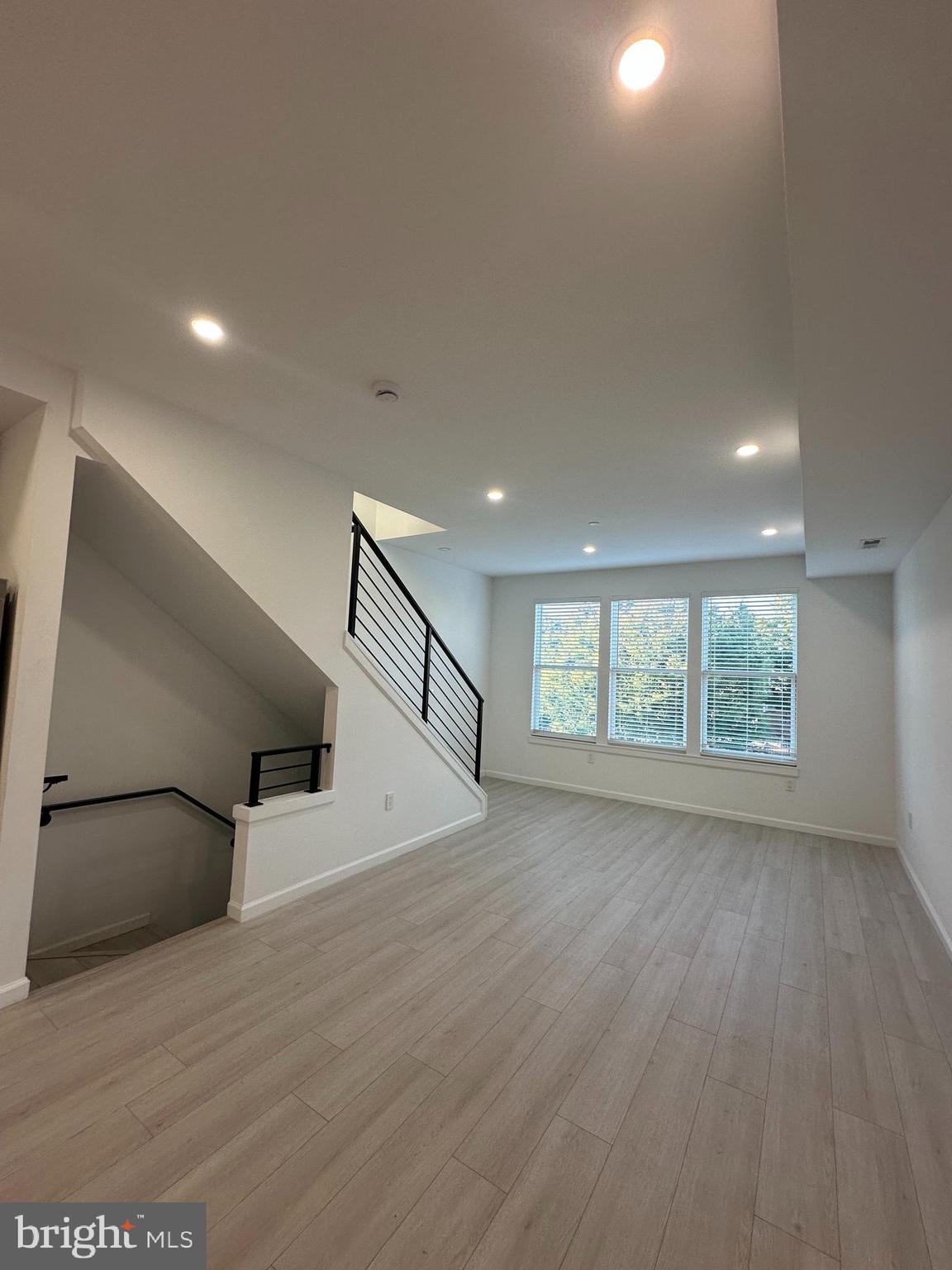 1925 H Street Northeast, Unit 3 Washington, DC 20002 - Photo 4 of 33 an empty room with wooden floor and windows