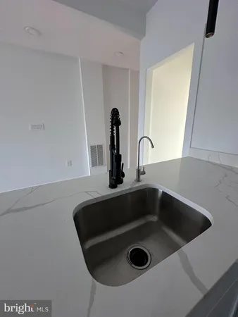 a kitchen with stainless steel appliances granite countertop a white refrigerator a sink a stove and a refrigerator