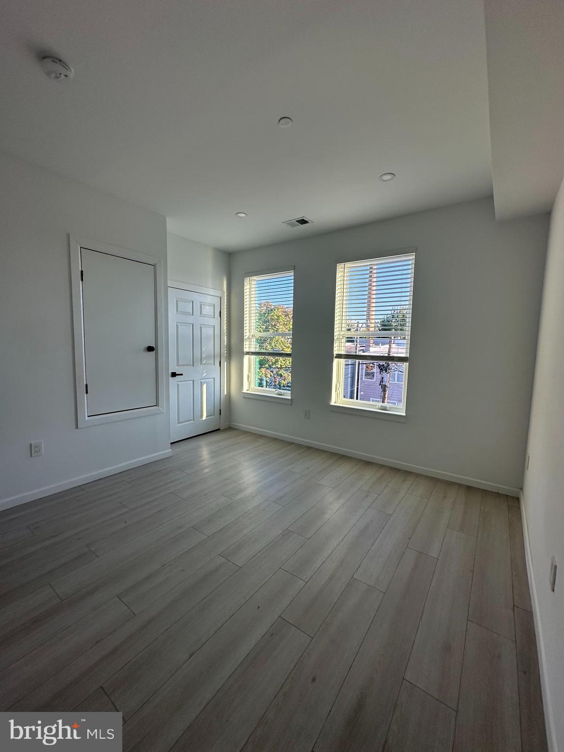 1925 H Street Northeast, Unit 3 Washington, DC 20002 - Photo 9 of 33 an empty room with wooden floor and windows