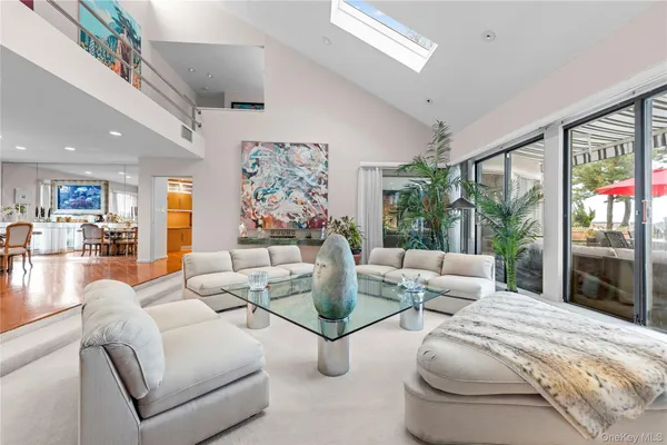 a living room with fireplace furniture and a large window
