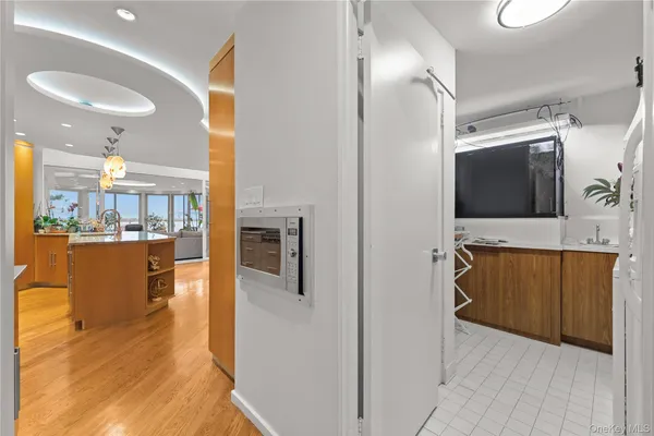 a view of hallway with kitchen island dining room and wooden floor