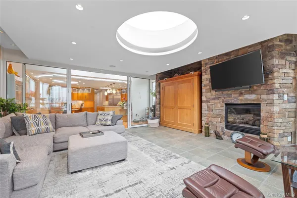 a living room with furniture a flat screen tv and a fireplace