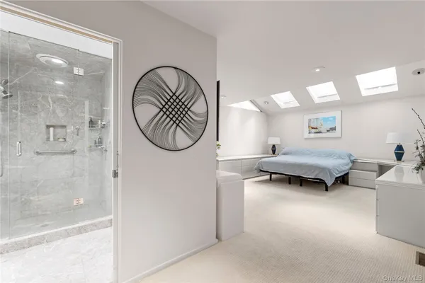 a living room with furniture a mirror and a glass door