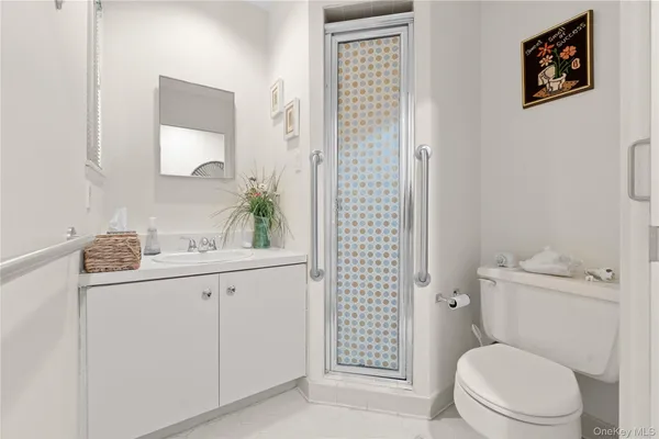 a bathroom with a toilet a sink and shower