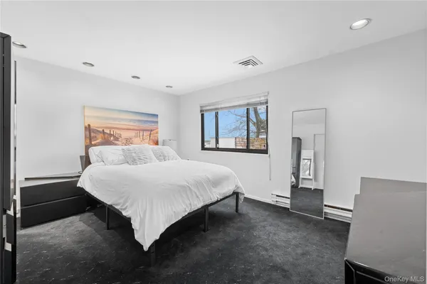 a bedroom with a bed and a night stand