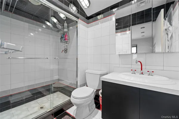 a bathroom with a sink a toilet and shower