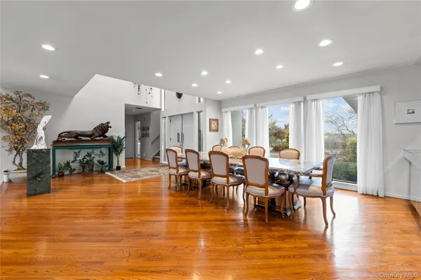 a living room with lots of furniture and a wooden floor