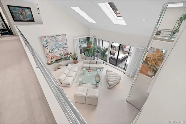 a view of a living room with furniture and wooden floor