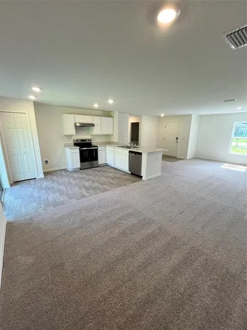 a view of a kitchen with a sink and a refrigerator