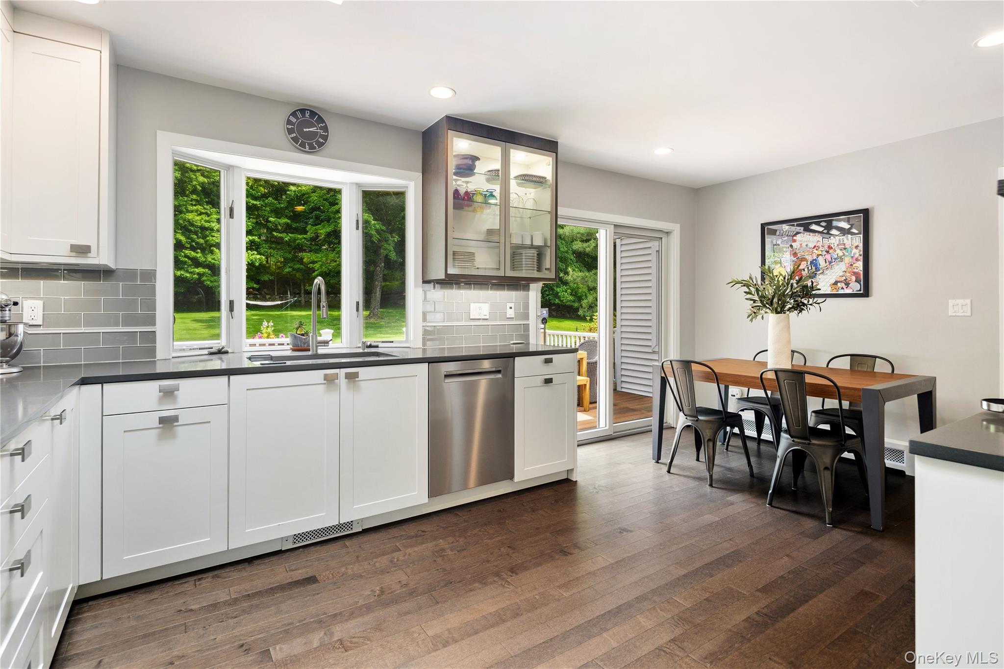16 Fox Den Road Mount Kisco, NY 10549 - Photo 22 of 44 Lit glazed display cabinets, bay window, breakfast area, sliders to deck, wood floors, recessed lighting, adjacent laundry room