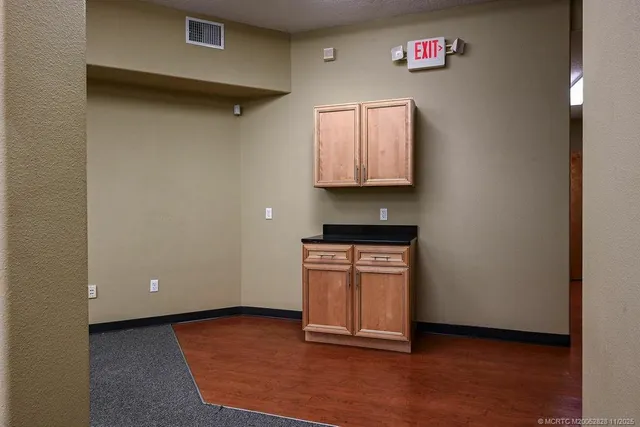 a view of cabinets and wooden floor