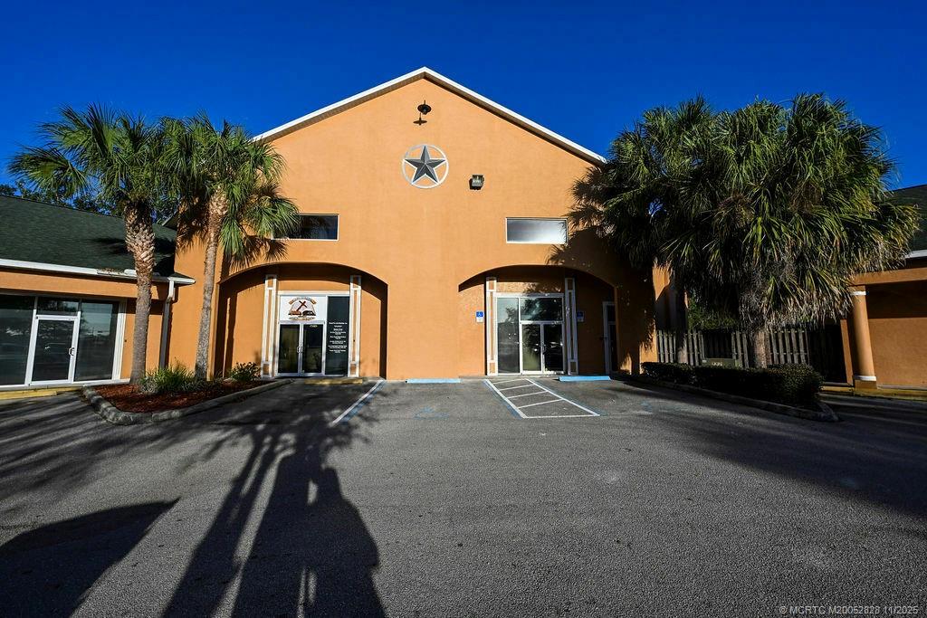 7177 South George Boulevard Sebring, FL 33875 - Photo 3 of 18 a front view of a house with a yard