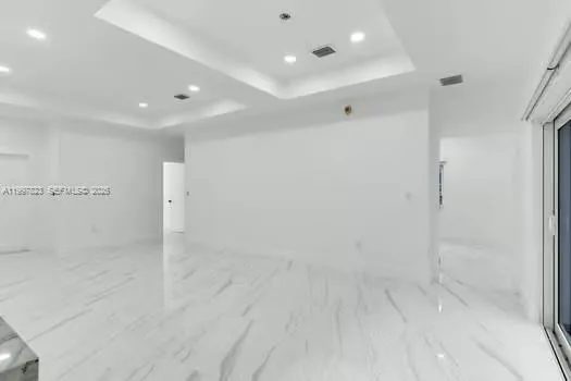 a kitchen with a center island appliances and cabinets