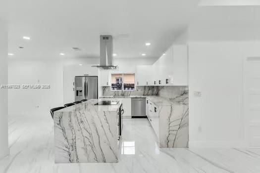 4127 Northeast 30th Street Homestead, FL 33033 - Photo 14 of 50 a kitchen with white cabinets and stainless steel appliances