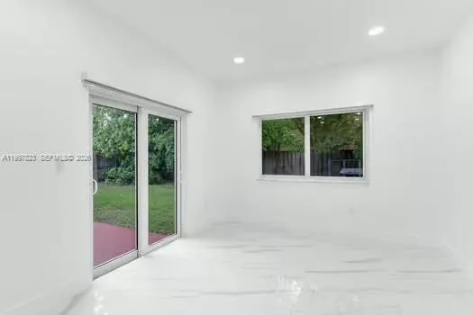 a view of a livingroom with a ceiling fan and window