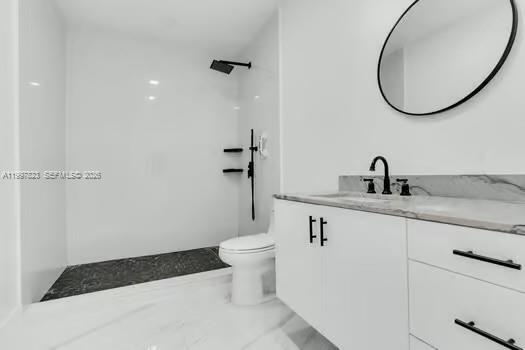 4127 Northeast 30th Street Homestead, FL 33033 - Photo 26 of 50 a bathroom with a granite countertop sink a toilet and a mirror