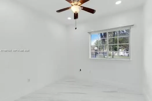 an aerial view of residential houses with outdoor space and ocean view