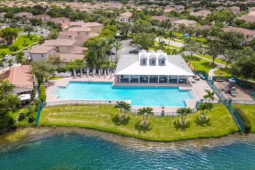 4127 Northeast 30th Street Homestead, FL 33033 - Photo 47 of 50 an aerial view of a house with swimming pool lawn chairs and large trees