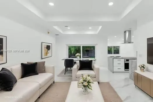 a view of a kitchen with furniture and an empty room