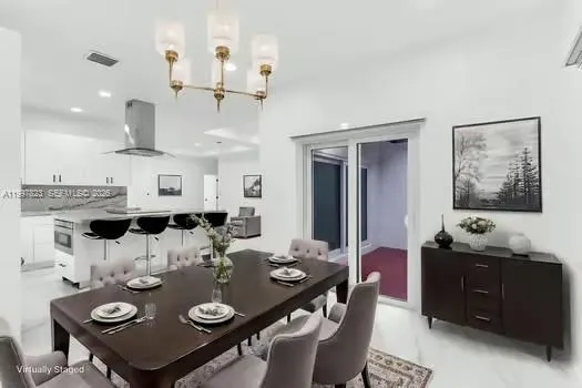 a kitchen with a sink and chairs