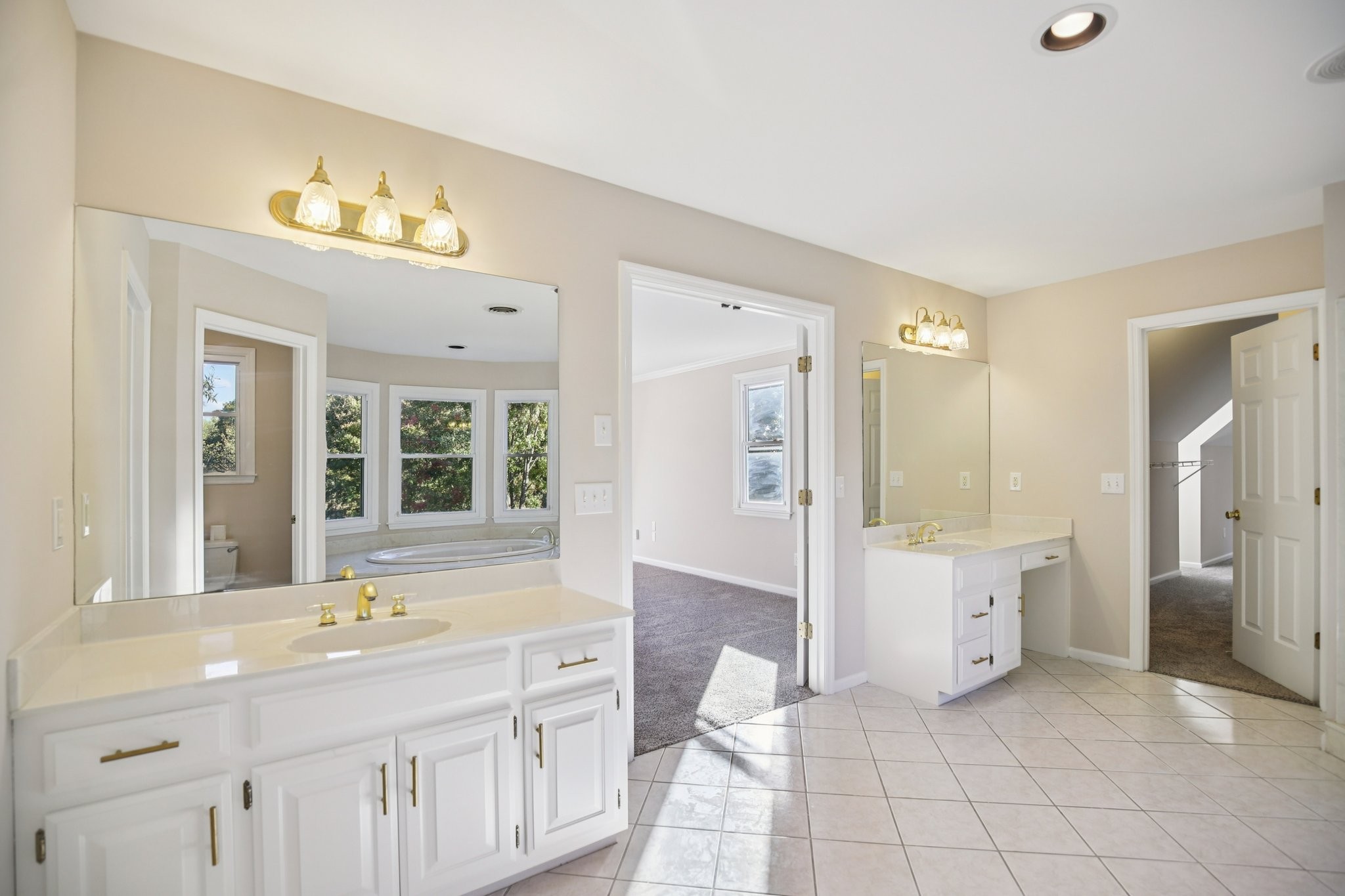 4026 Windland Drive Springfield, TN 37172 - Photo 17 of 32 a spacious bathroom with a double vanity sink a mirror and a bathtub