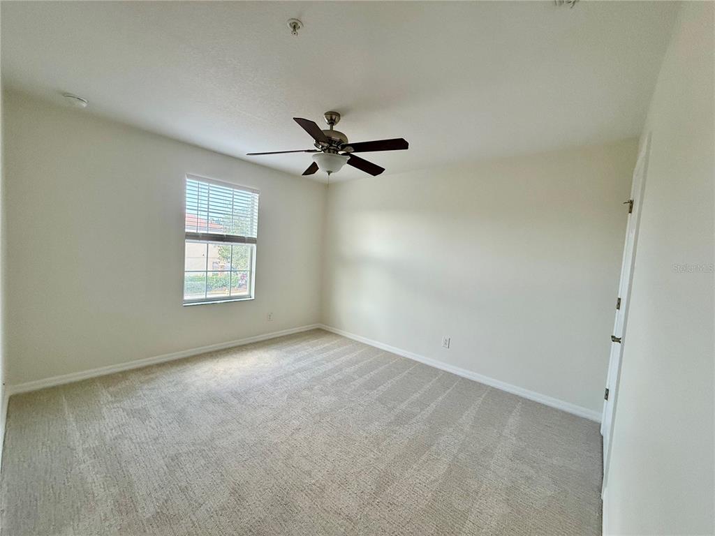 2090 Water Tupelo Way Ocoee, FL 34761 - Photo 20 of 43 an empty room with a window and a ceiling fan